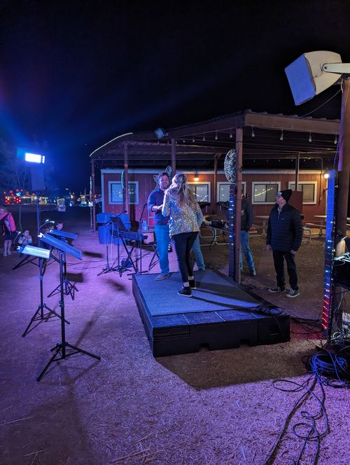 Two performers on the lit stage during the evening comedy show.