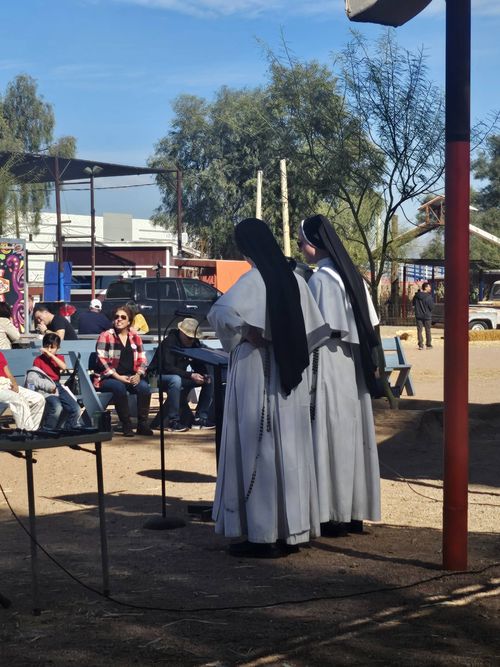 Two sisters speaking to the crowd from the festival stage.